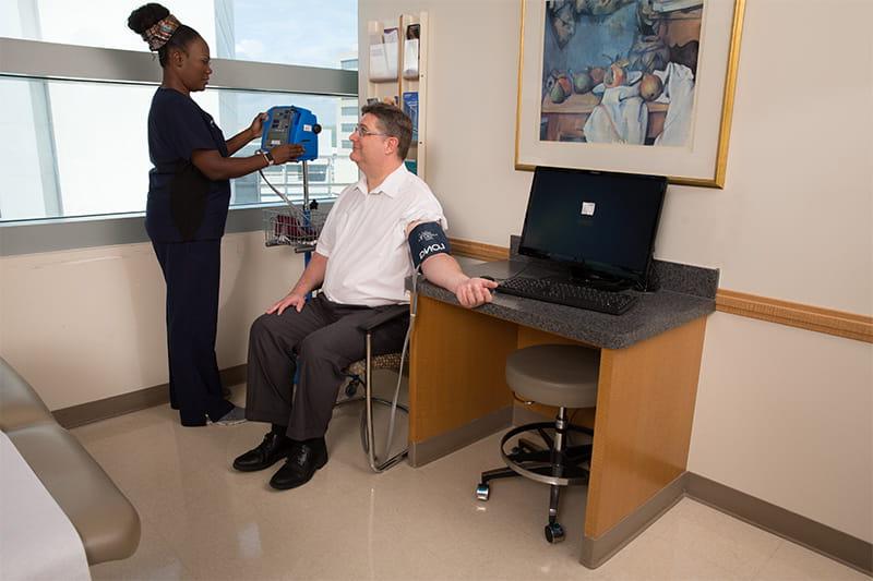 nurse checking a patient's blood pressure