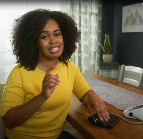 woman checking her blood pressure at home